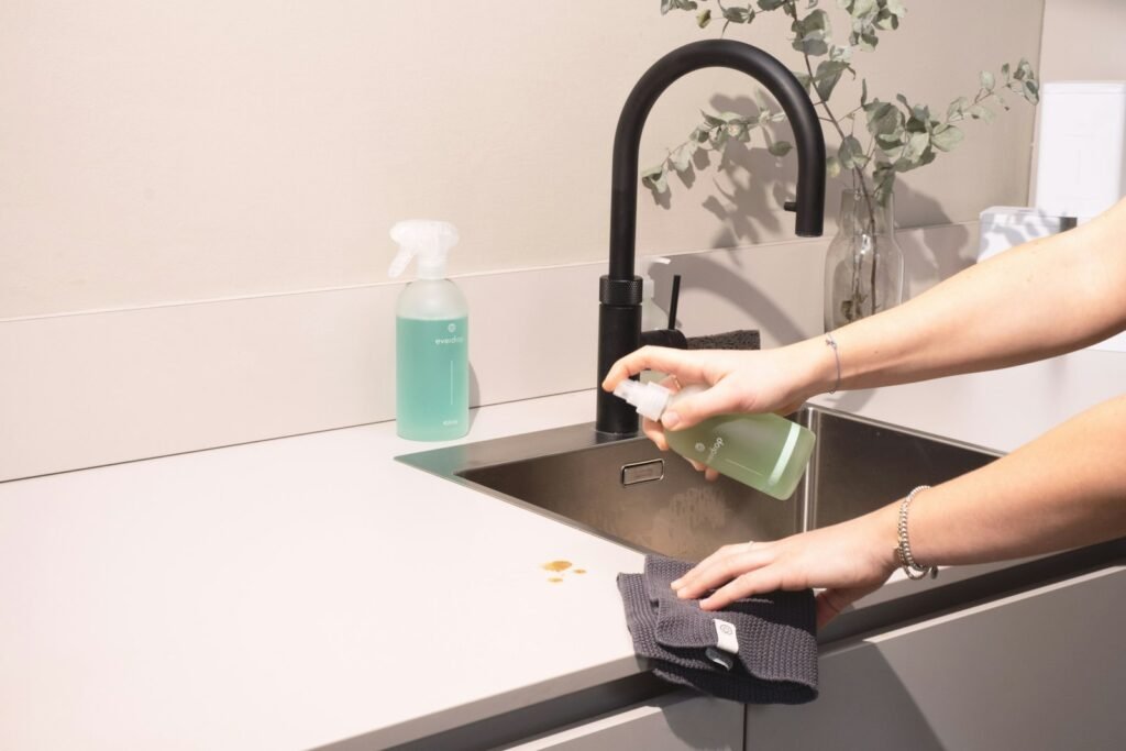 Cleaning a kitchen sink with a cloth
