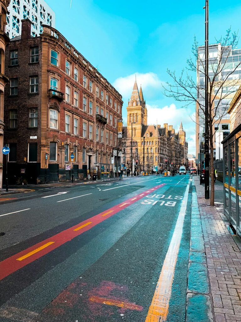 A Manchester street with the Town Hall clock tower